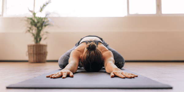 A woman stretching out while using yoga for Upper Cross Syndrome