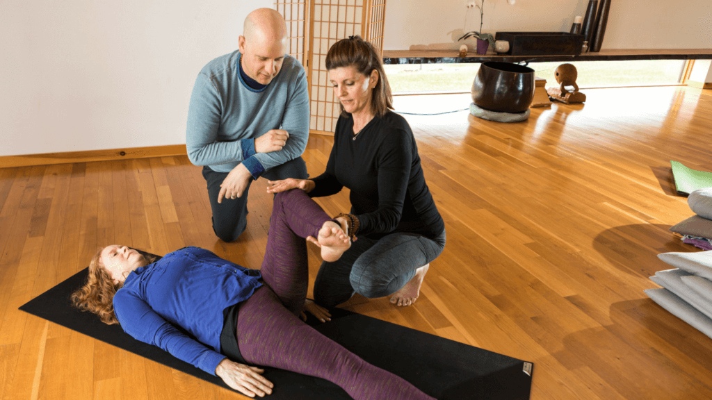 Brandt working with a yoga therapy student on asana, demonstrating one of the benefits of yoga for nurses