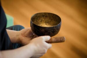 Brandt Passalacqua holds a small singing bowl.